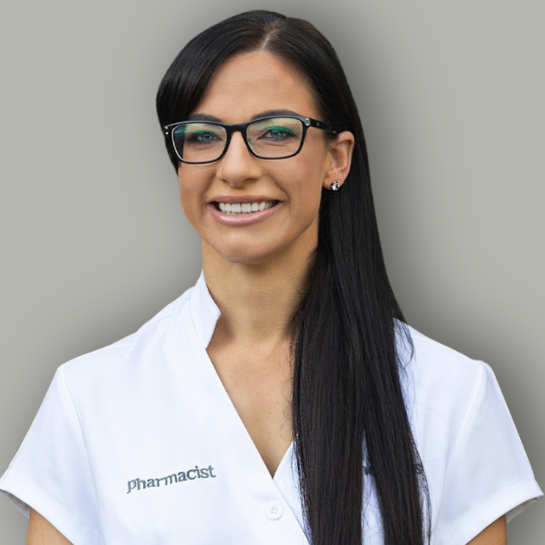 Woman wearing a white lab coat with 'Pharmacist' text on a gray background